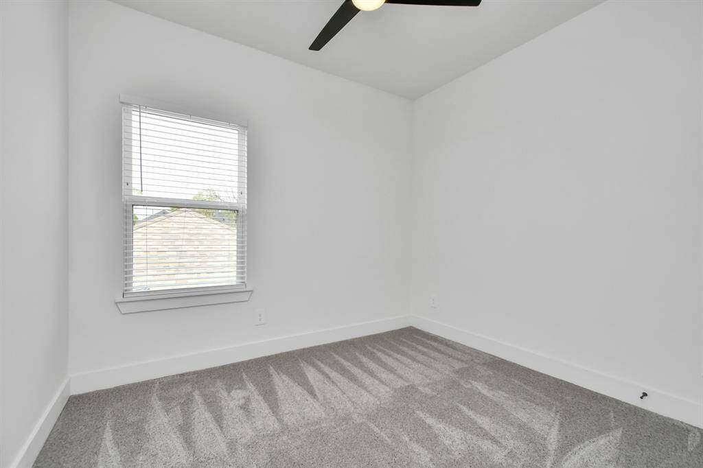 Retreat to the tranquility of 1 of 2 spacious guest bedrooms, featuring elegant ceiling fan, walk in closet, plush carpet and ample natural light for a serene and inviting ambiance