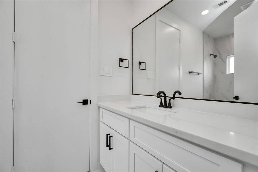 Indulge in the luxury and convenience of the Jack and Jill bathroom adjoining both guest bedrooms featuring generous vanity, ample space for your toiletries and personal essentials