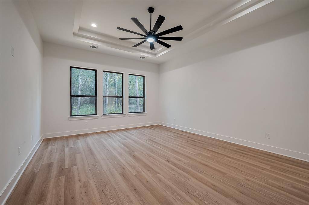 Primary bedroom with tray ceilings for a classic finish