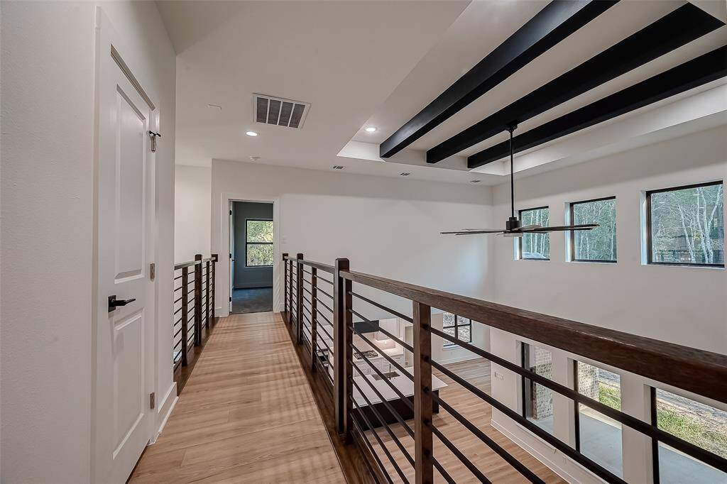 Upstairs walkway leading to the secondary bedroom with its own bathroom