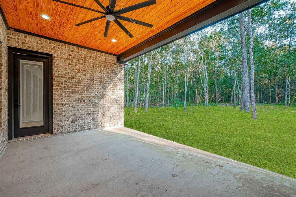 Faux wood planks with recessed lighting add a vibrant touch to the covered patio