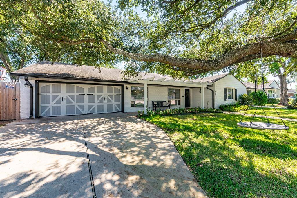 Charming single-story home with a welcoming facade, featuring a large, shady tree in the front yard. A curved walkway leads to the entrance, surrounded by a well-maintained lawn and landscaping. Ideal for buyers seeking a cozy, inviting property.