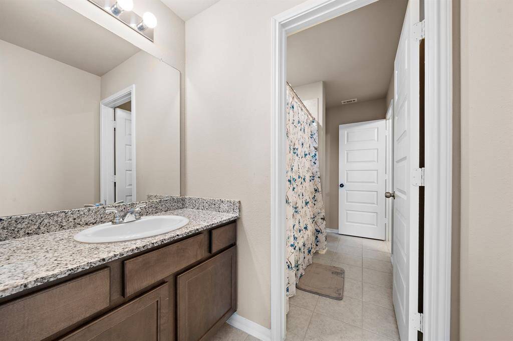Full ensuite bathroom connecting two bedrooms on second level