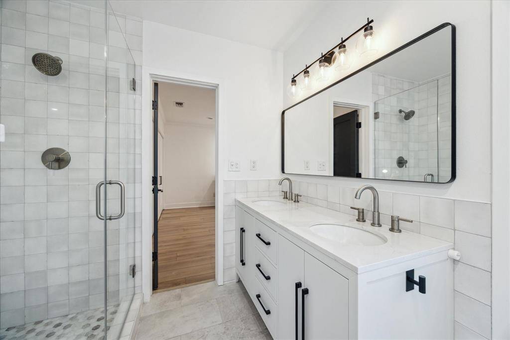 Renovated from top to bottom with tasteful finishes, including polished hexagon marble shower flooring and elegant quartz countertops