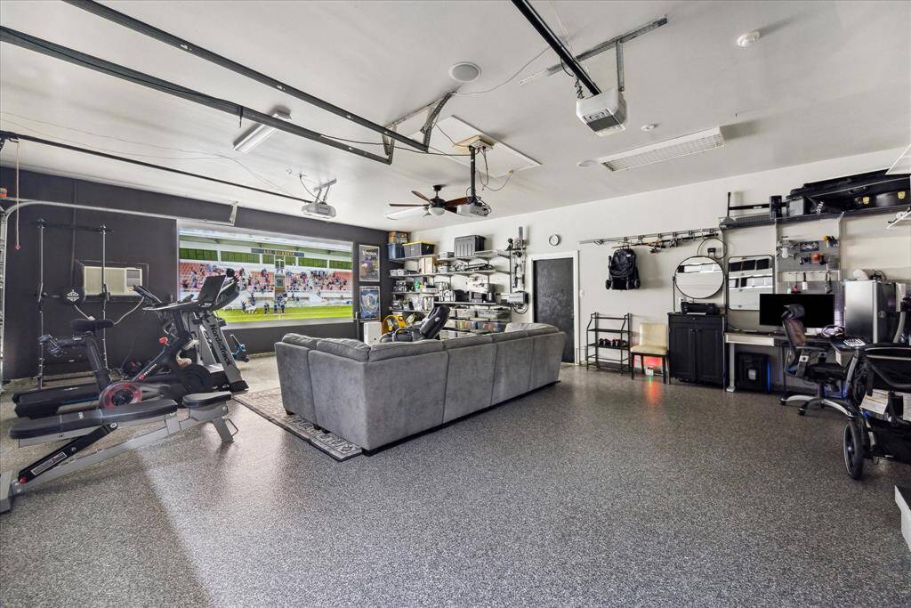 This epoxy-coated, air-conditioned and heated 3-car garage provides a versatile space