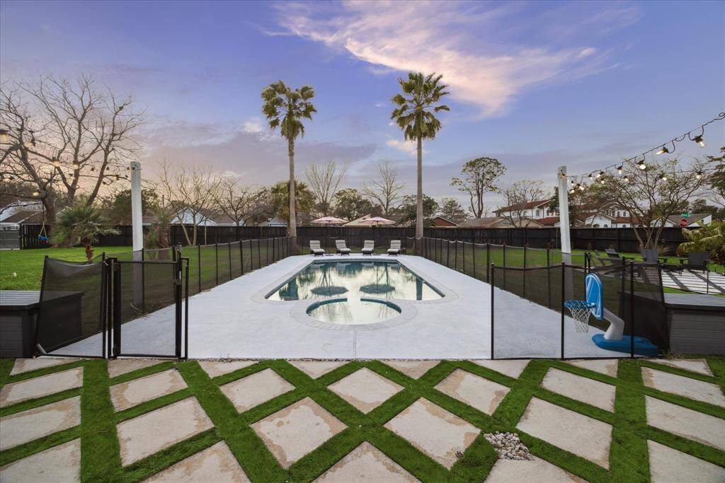 This tricked-out saltwater pool is ready to impress, resurfaced w/ PebbleSheen PebbleTec, new heat-reflective spray deck, glass/tile coping, lights, skimmers, fill line, heater.