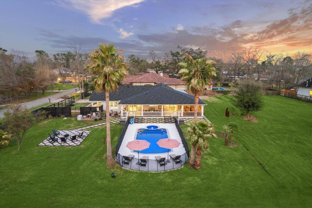 44,000 sq ft lot! Property is comprised of two adjoined lots. Home and pool sit on the front lot, the back half is open