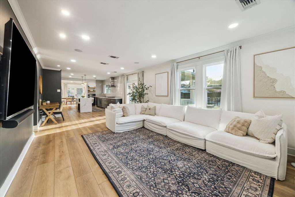 Natural light floods the space w/ double-paned windows, plantation shutters throughout