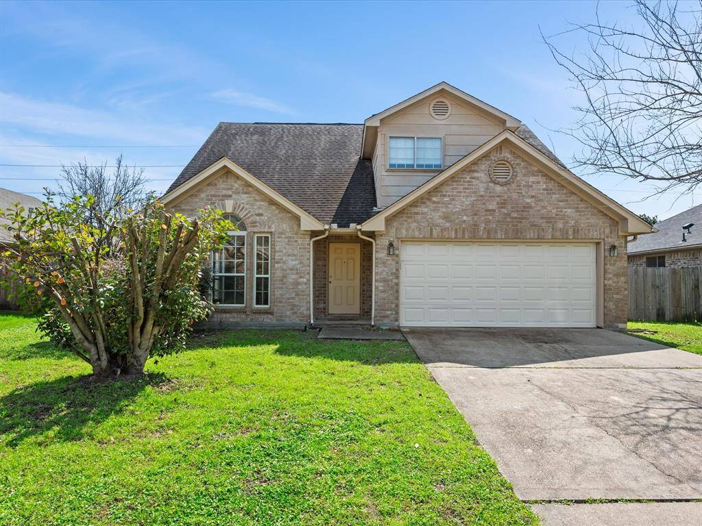 This charming home features a classic brick exterior and two-car garage.