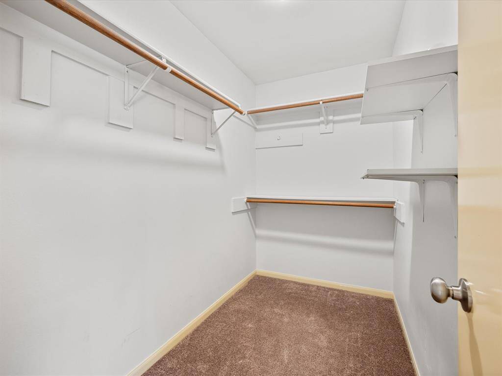 Primary bedroom walk-in closet