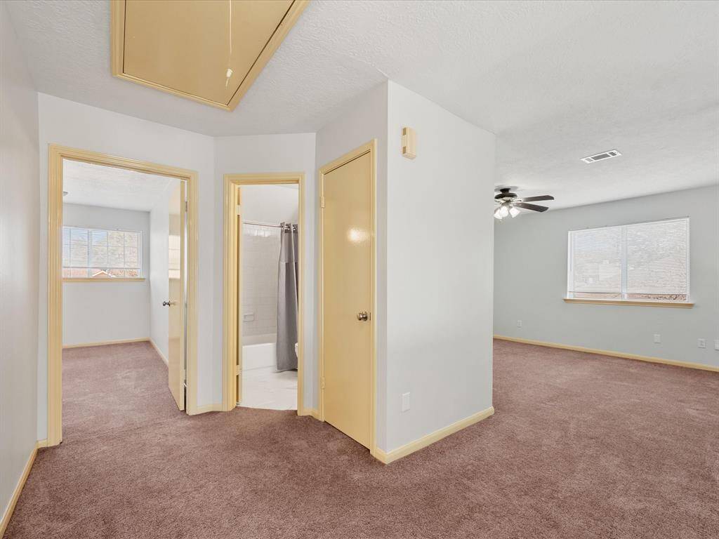 Upstairs hallway leads to two bedrooms, a full bathroom, and a loft space.