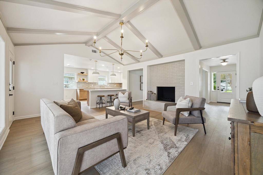 THE FAMILY ROOM HAS A HANDSOME BRICK FIREPLACE AND MAKES A GREAT FOCAL POINT ADDING WARMTH AND CHARM.