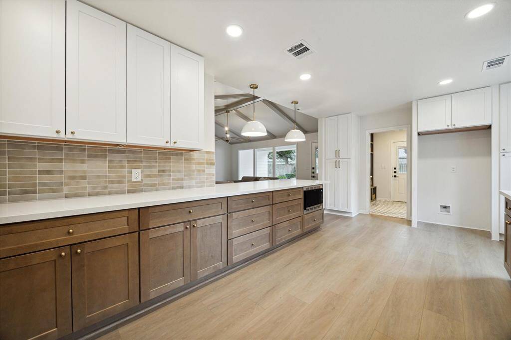 THERE IS PLENTY OF SPACE FOR AN OVER-SIZED REFRIGERATOR. THE OPENING LEADS THROUGH TO THE SPACIOUS MUD/UTILITY ROOM.