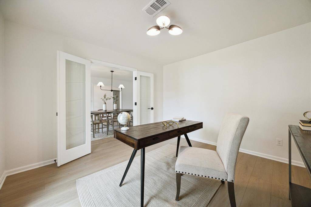 ANOTHER VIEW OF THE STUDY WITH GLASS DOUBLE DOORS PROVIDING PRIVACY WHEN NEGOTIATING BUISNESS DEALS FROM HOME!