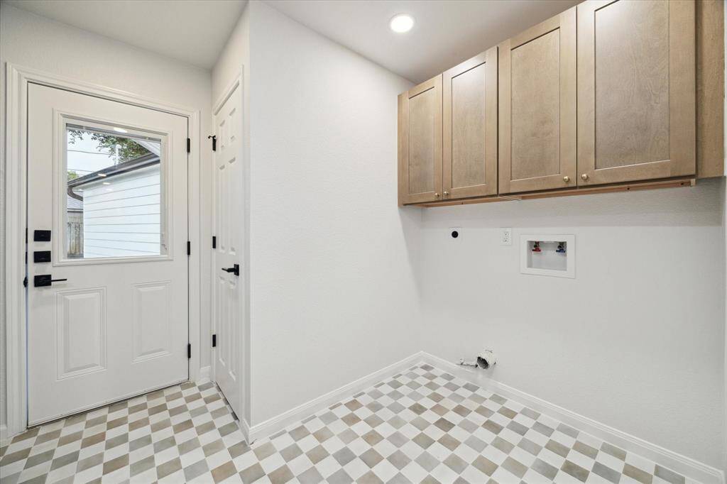 ANOTHER VIEW OF THE UTILITY ROOM WITH ADDITIONAL USEFUL CABINETS.