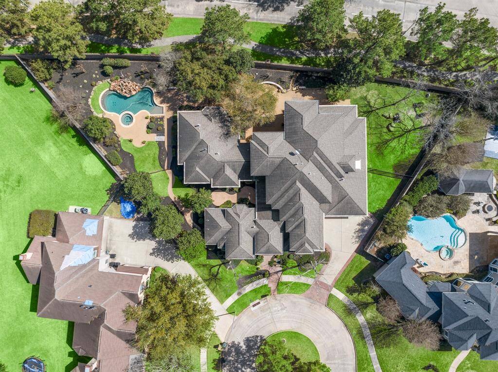 Stunning evening view of this Bob Hale custom home with elegant front elevation, beautifully illuminated against the twilight sky.