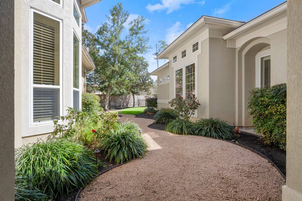 Charming gravel path leading to a serene pool oasis.