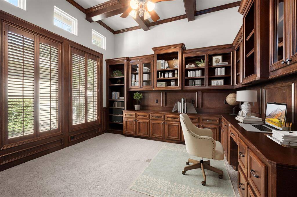 Elegant home office featuring custom built-ins for stylish organization. Virtually staged.