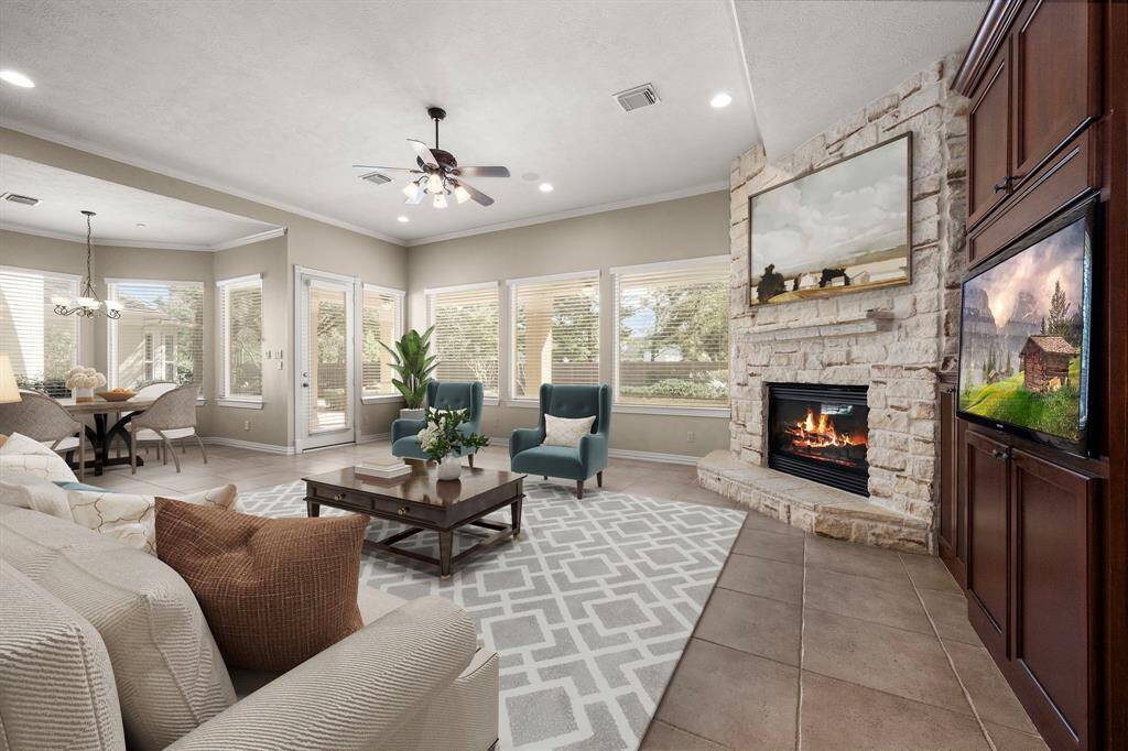 Walls of windows across this family room gives you a stunning view of the backyard.