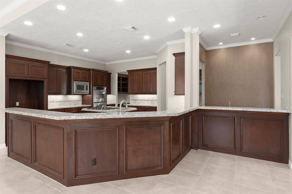 This inviting breakfast bar offers ample seating and a stylish space for casual dining and entertaining.