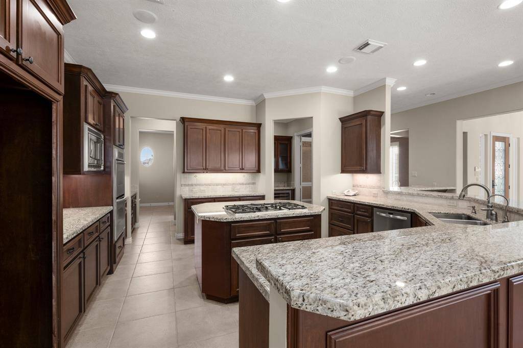 Spacious island kitchen with elegant cabinetry and modern appliances, perfect for cooking and entertaining.