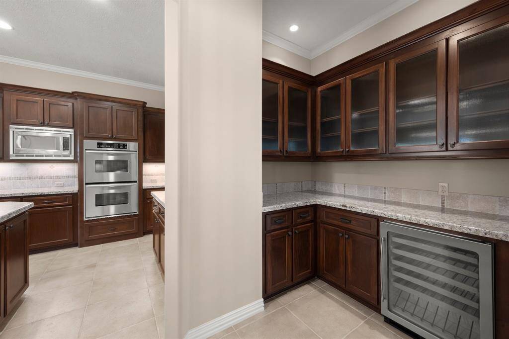 Elegant butler's pantry featuring a temperature-controlled wine fridge.