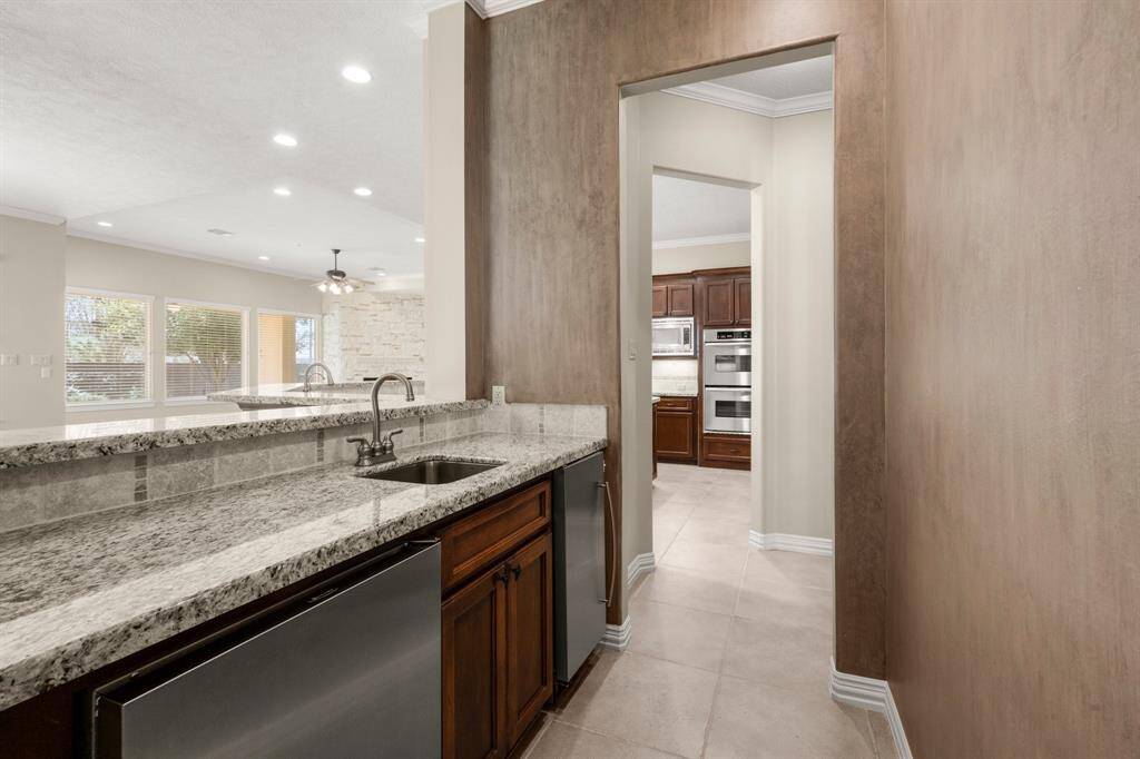 Experience luxury with this elegant wet bar, perfect for entertaining guests and enhancing your living space.