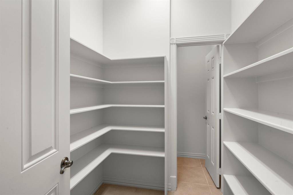 Spacious walk-in pantry with ample shelving for all your storage needs.