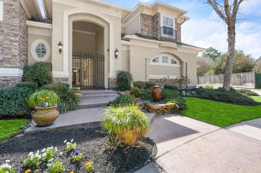 Stunning front exterior with elegant architecture and lush landscaping.