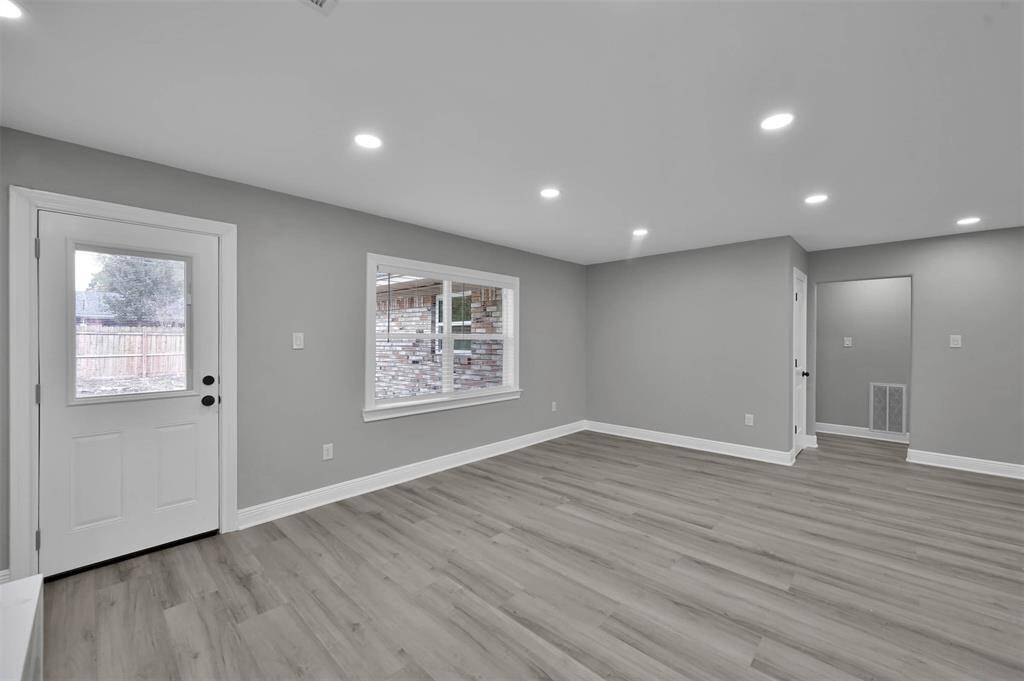 This dining area could easily accommodate a sizeable dining table for large gatherings.