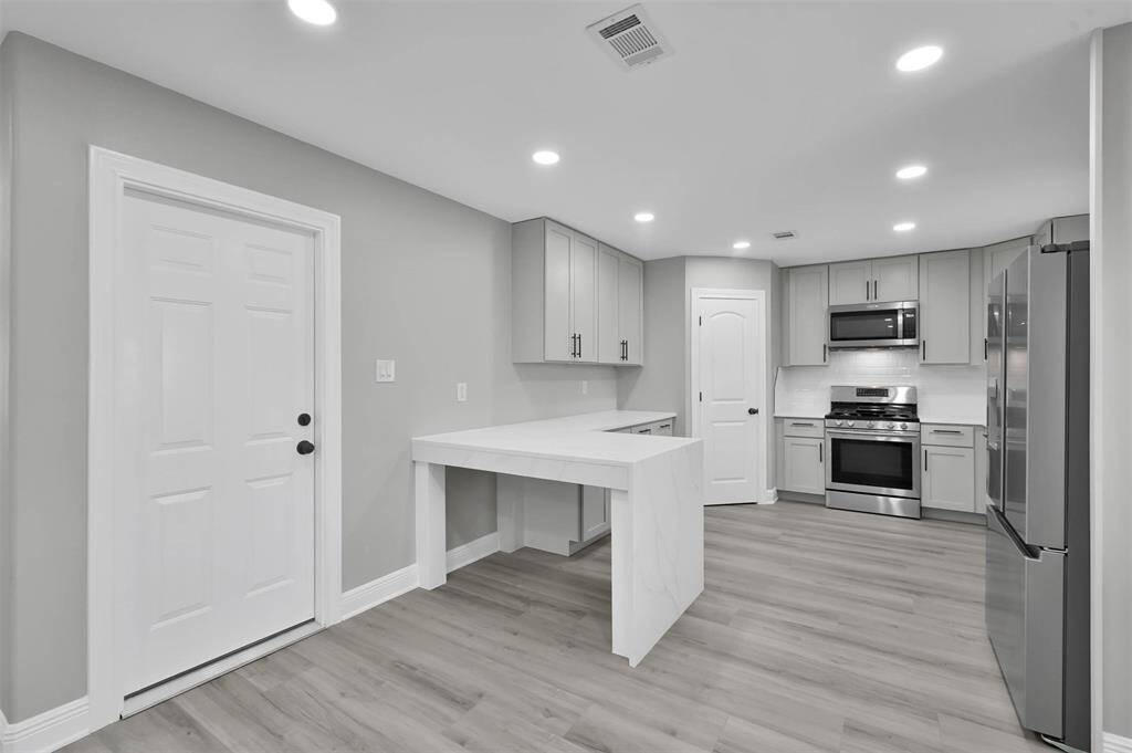 Next we'll take a look at the completely renovated kitchen. All new stainless steel appliances are included!