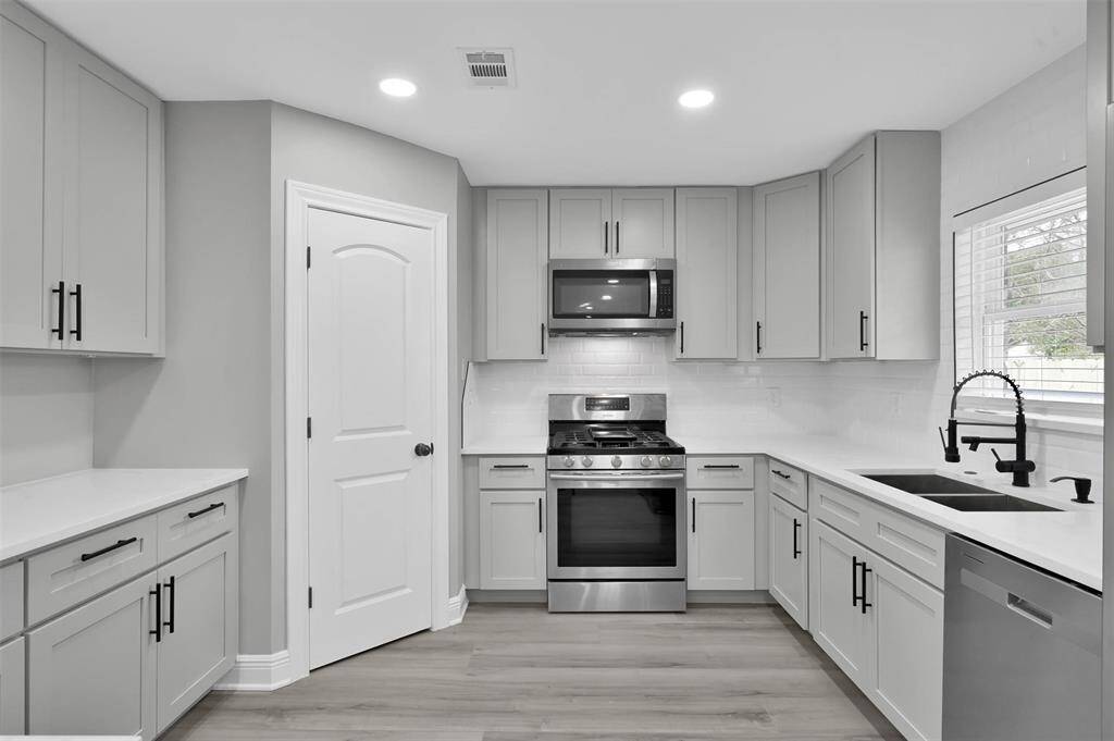 The sink at the window provides a great view. The cabinets go all the way up to the ceiling providing a high end finish to the kitchen.