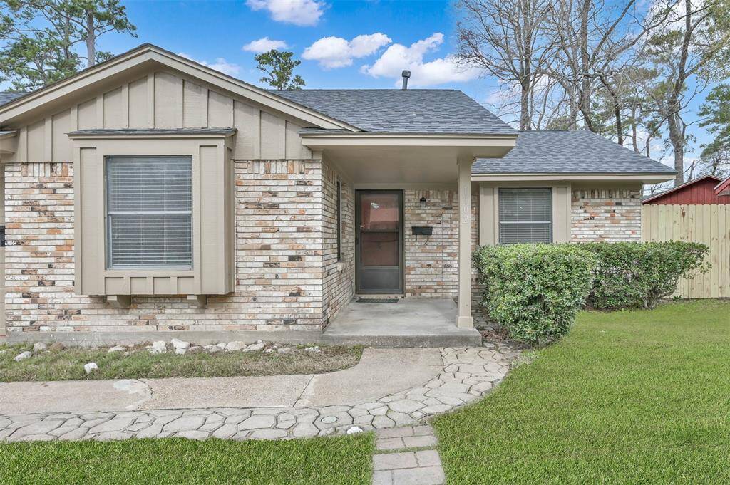 Following the stone paved pathway to your front entrance, you're greeted with a covered patio and the tasteful red door.