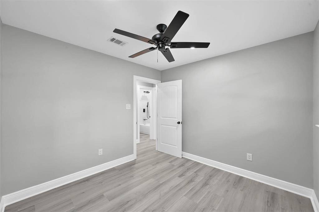 Another view of Bedroom 3. Notice that all of the bedrooms and the living room have a sleek black ceiling fan to keep you cool.