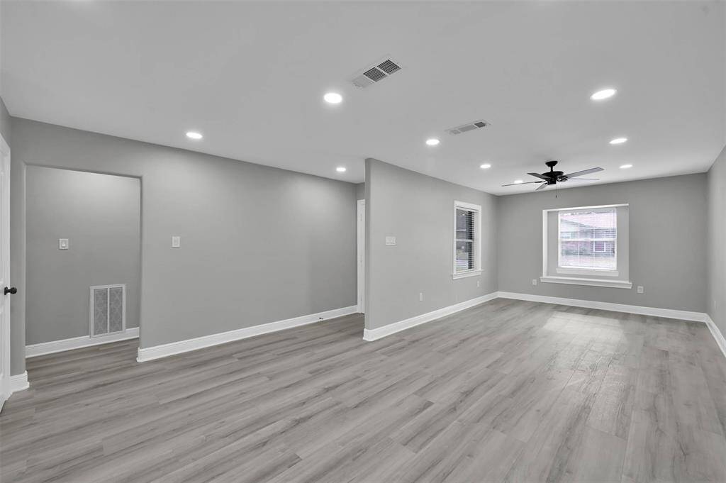 Here is another view of the front entry and living room. Plentiful recessed LED lighting helps keep this home bright and airy while prioritizing your efficient electric bills.
