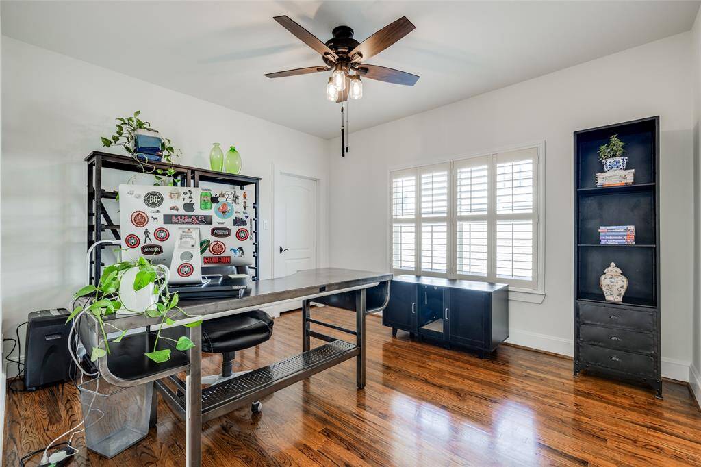 Bedroom 2 with hardwood floors, large storage closet, access to Jack & Jill bathroom, plantation shutters, ceiling fan, recently painted
