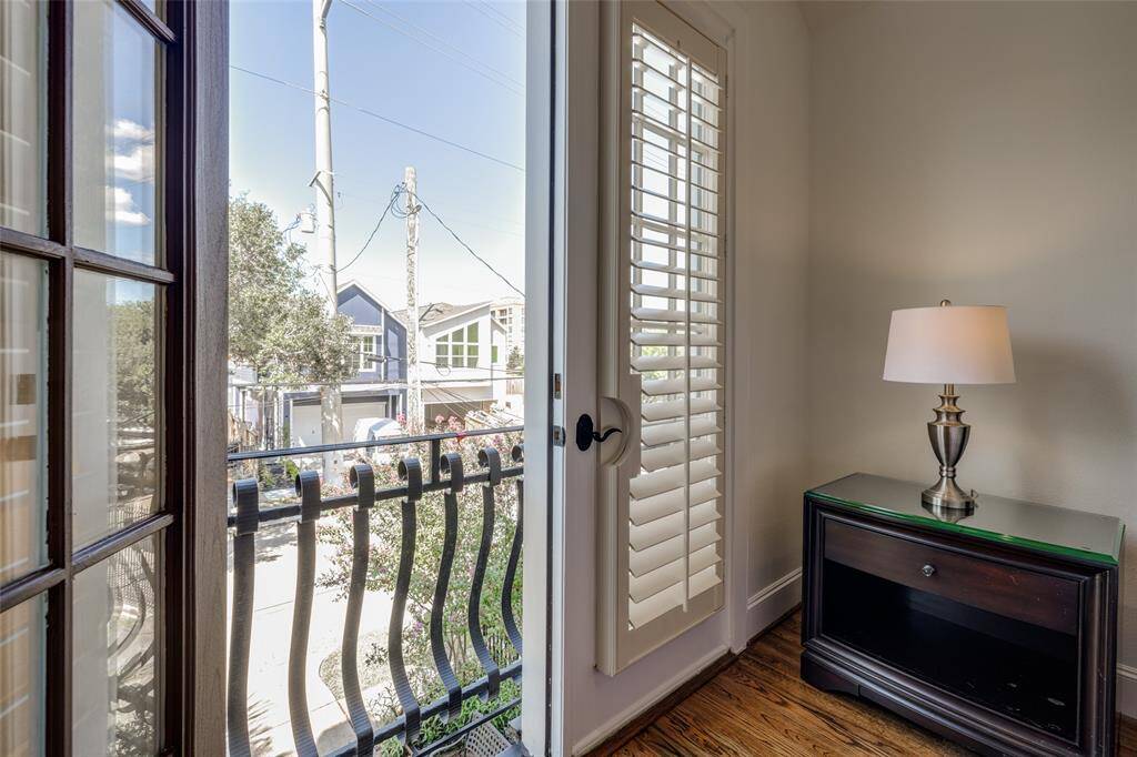 Enjoy Houston's good weather  -  primary bedroom doors open out to the front of the home - beautiful wrought iron balcony rails