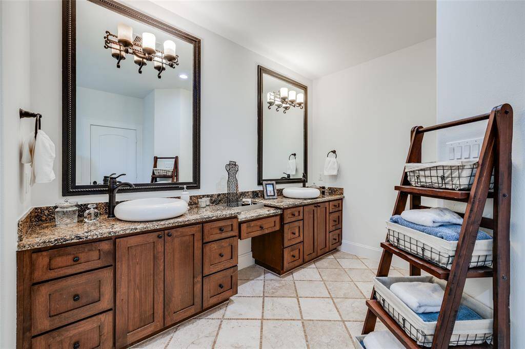 Huge Primary bathroom with corner jacuzzi bath, large mirrors, dual vanities, oil rubbed bronze fittings, lots of drawers for storage