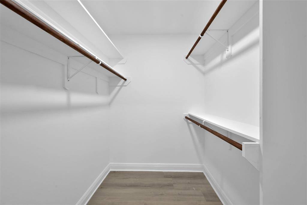 The primary walk-in closet has plenty of space and options for all your storage needs.