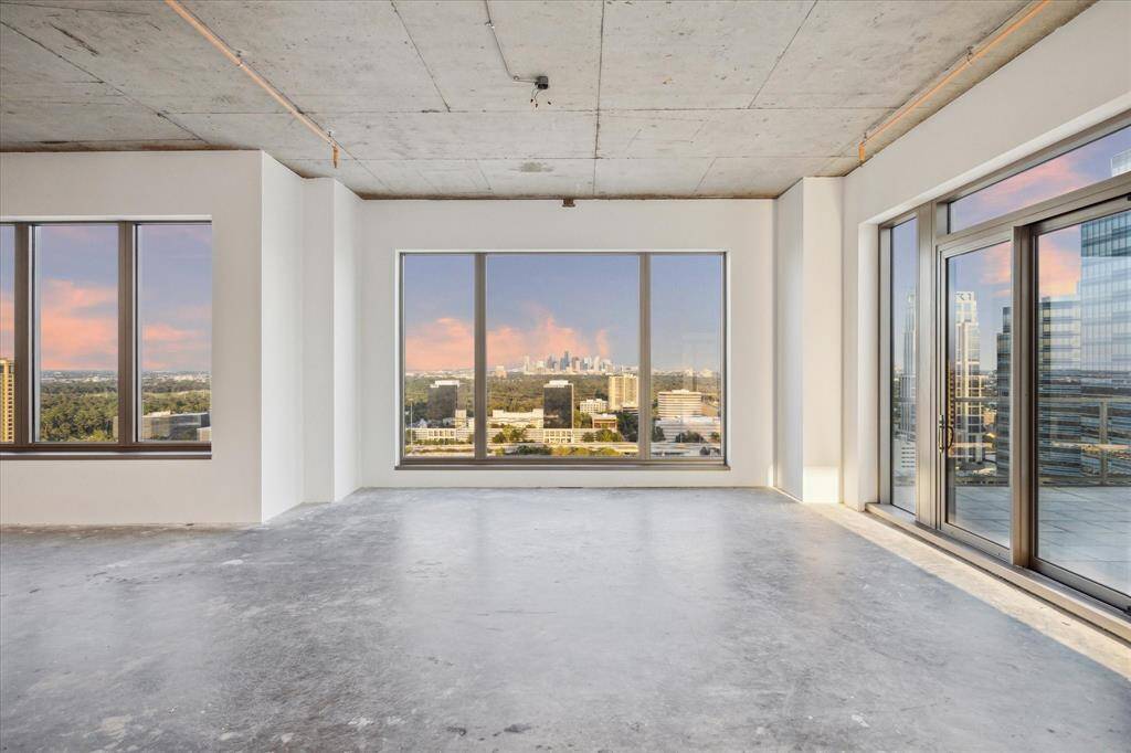 FORMAL DINING ROOM - Elevate your dining experience in this formal dining area, where expansive windows frame unobstructed downtown views from the 25th floor. The space seamlessly connects to the East Terrace, offering the perfect setting for al fresco dining or entertaining with a stunning city backdrop. Designed for sophistication, this dining room allows you to enjoy both luxury and breathtaking panoramas.