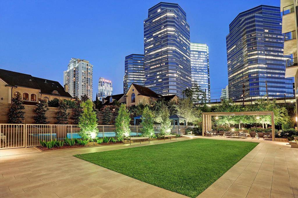 OUTDOOR RETREAT - Relax and unwind in the beautifully landscaped green space, complete with a cozy sitting area and BBQ zone, perfect for entertaining or peaceful outdoor moments. With stunning lighting that enhances its charm both day and night, this serene spot at the Belfiore condominium offers an inviting atmosphere for any occasion.