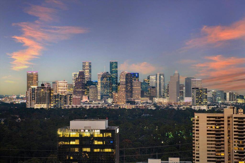 VIEW FROM EAST TERRACE - Marvel at the sparkling downtown skyline from the expansive East-facing balcony on the 25th floor of the Belfiore penthouse. This unmatched view offers a breathtaking panorama of Houston's city lights, creating an extraordinary backdrop for outdoor living and entertaining.