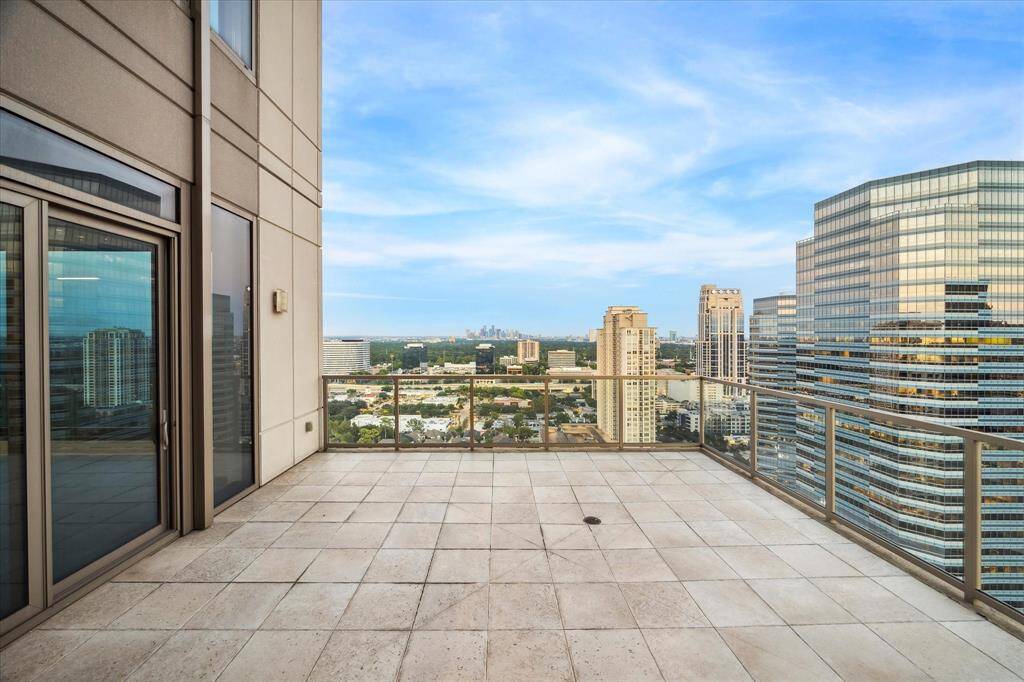 EAST TERRACE - Enjoy 690 square feet of total outdoor space on the expansive 25th-floor terraces of the Belfiore penthouse. The East-facing balcony offers a direct access to the formal dining room and living room. This spacious setting takes in sweeping views of Houston's skyline, combining luxury living with breathtaking panoramas.