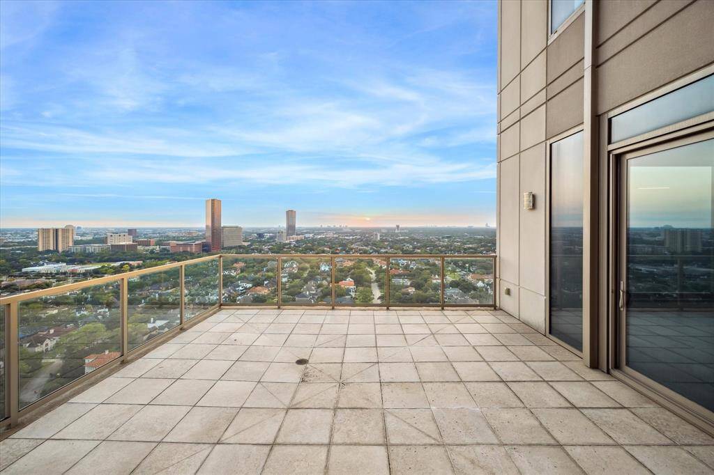 WEST TERRACE - Relax on the expansive West-facing terrace, seamlessly connected to the living room and study, as envisioned in Kirksey Architecture's floorplan. This unobstructed view offers endless vistas over Tanglewood and is the perfect setting to enjoy breathtaking sunsets. Experience luxurious outdoor living with a serene backdrop of Houston’s natural beauty.