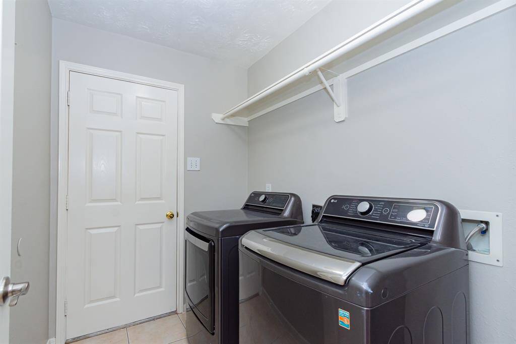 Laundry room in home with washer and dryer