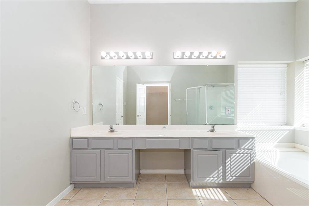 Primary bathroom with dual sinks and huge soaking tub