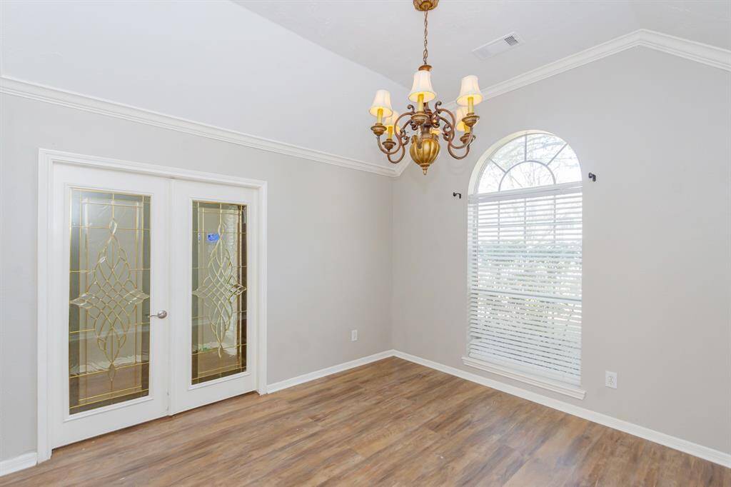 This room can be used as a formal dining room or office
