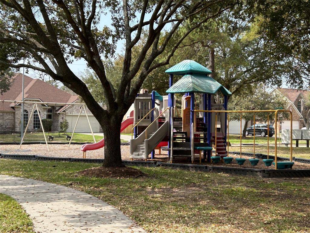 Playground surrounded by walking trail and shade trees!