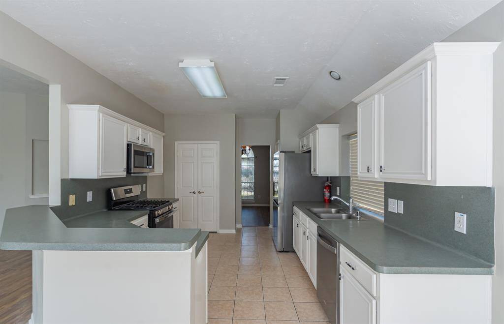 View into kitchen that offers you plenty of counter and cabinet space. Kitchen is next to formal dining room, or if you prefer your office!