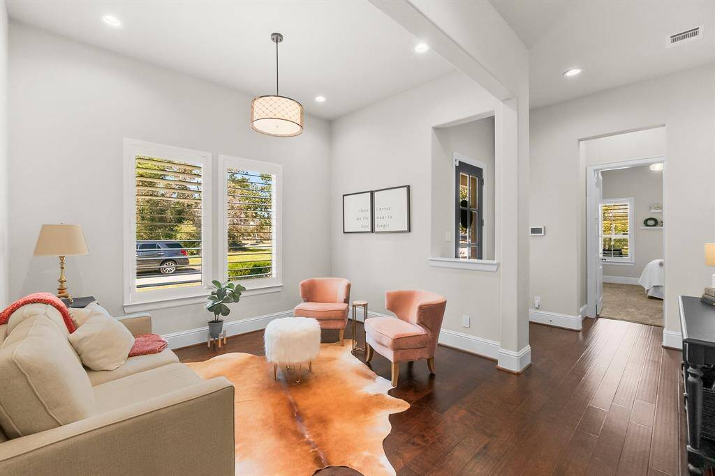 Bright and inviting sitting area with front door and and doorway to bedroom with private bath.